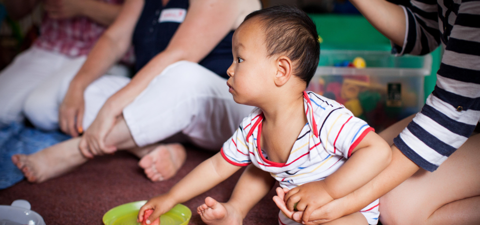 Baby boy eating a fruit