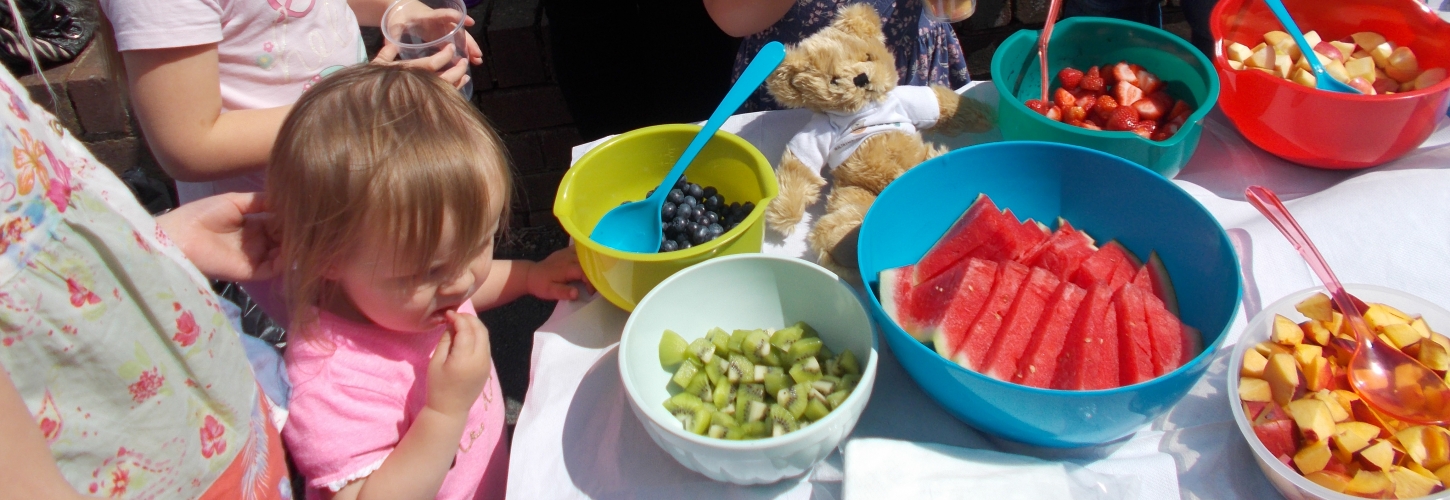 young children enjoying fresh fruit