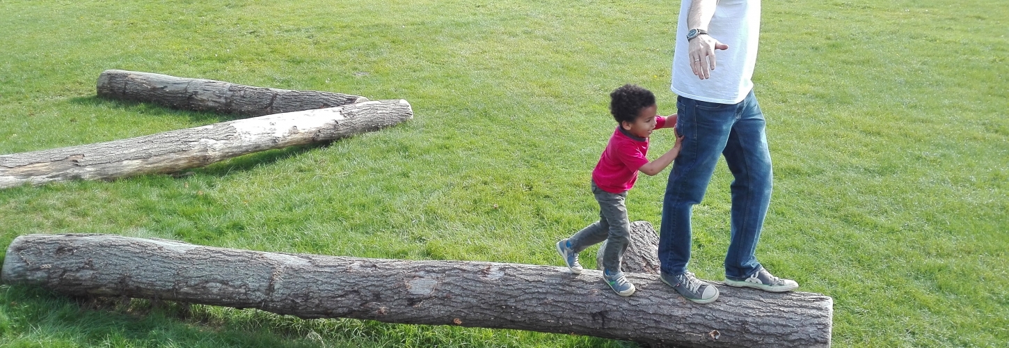 Young boy playing with dad outdoors