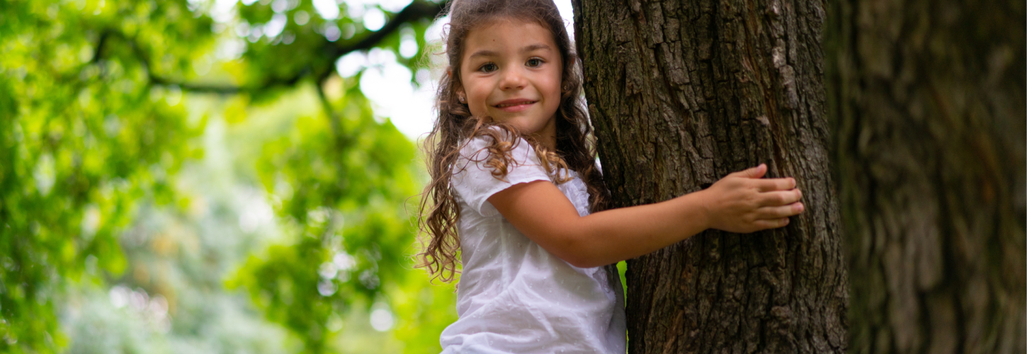 Little girl climbing in a tree