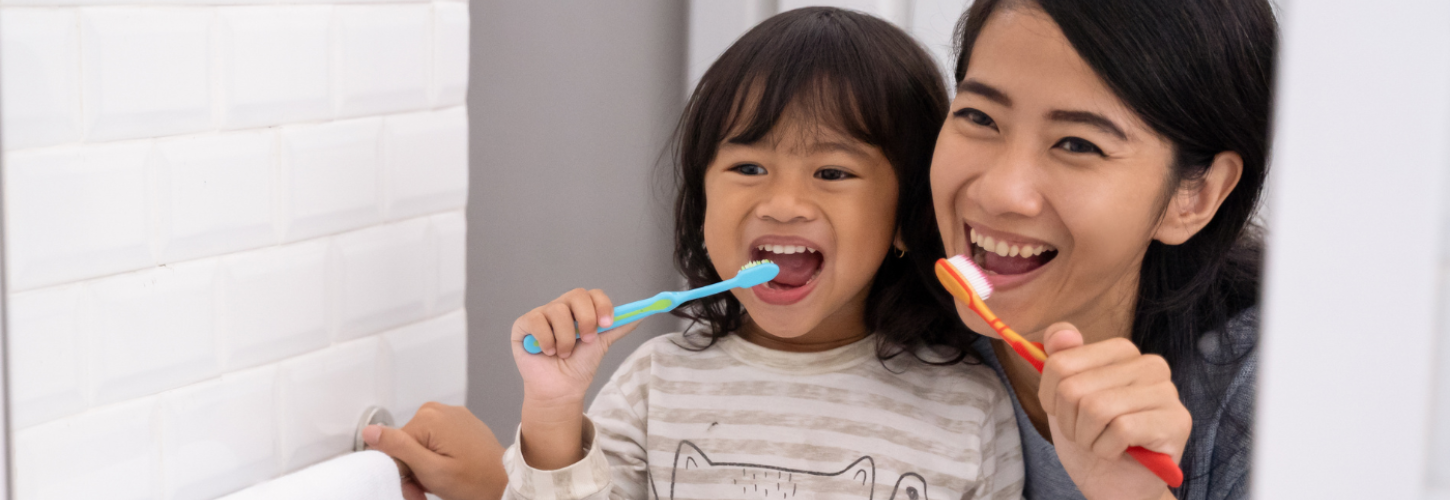 mum and young girl brushing their teeth together