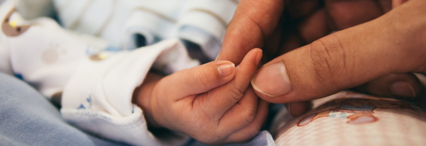 mother hand holding their newborn hand