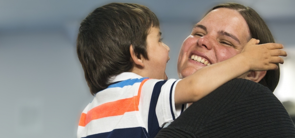 mum and little boy laughing and hugging