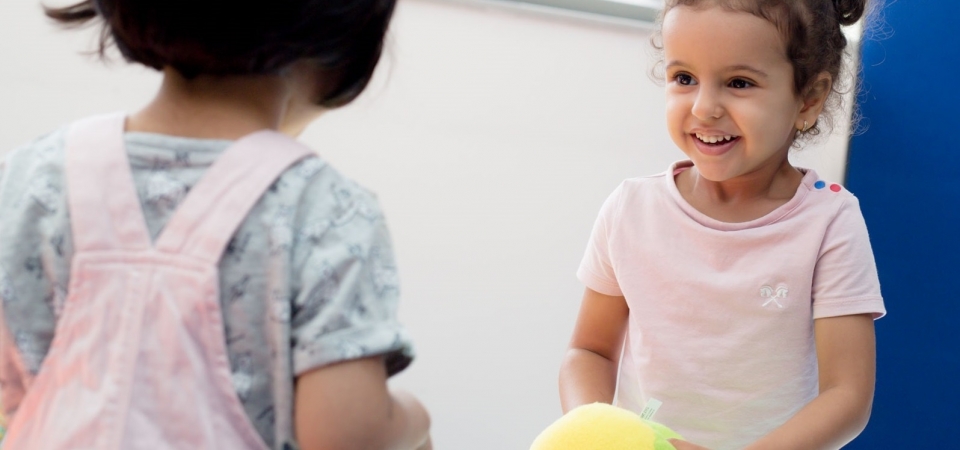 Two children playing with ball