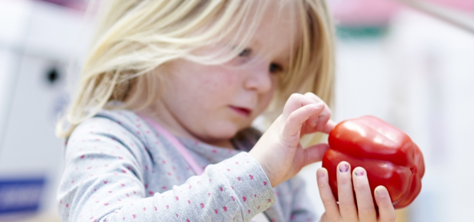 Little girl with pepper