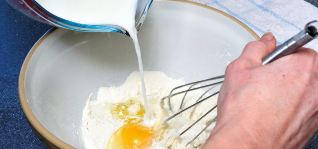 flour, eggs and milk in bowl